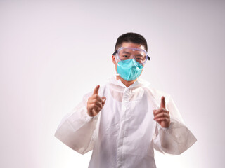 A health care worker wearing a mask and protective clothing on a solid color background