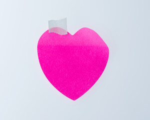 Heart-shaped adhesive note isolated on white