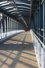 empty glazed overpass tunnel across the road