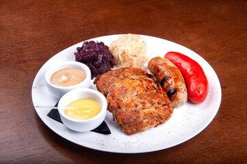 oktoberfest - potato pancakes with bratwurst and bock wurst red cabbage sauerkraut and mustards