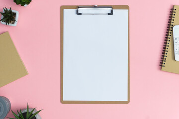Mockup on pink background. Office desk working space with blank form, coffee cup, succulents and notebook.