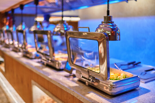 All inclusive buffet food in heating trays in hotel restaurant