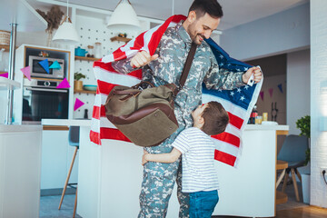 Young soldier just arrived home and he is so happy to see his son. Happy male soldier dad reunited...