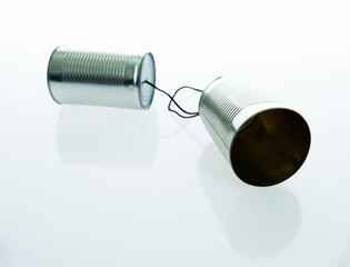 Tin can telephone with cord isolated on white background