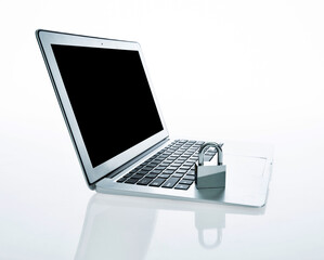 Single padlock on laptop keyboard against white background