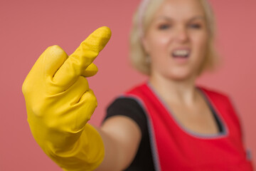 close-up woman cleaner in protective gloves showing middle finger