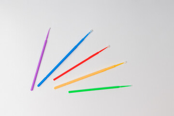 micro brushes dental, multi-colored plastic instruments on a white background