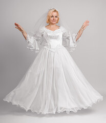 bride in white dress with puffy long hem, full length, studio shot