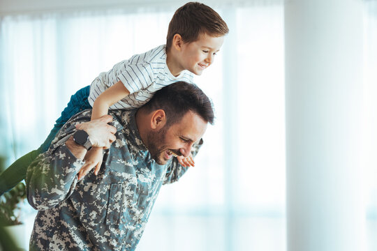 Military man father hugs son. Portrait of happy american family. Young soldier just arrived home and he is so happy to see his son. My Hero is back home