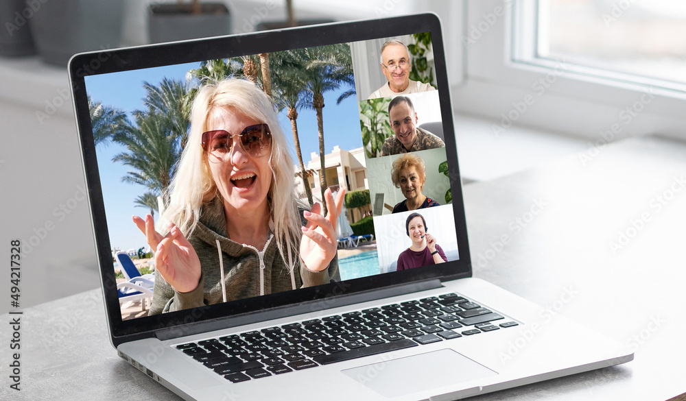 Wall mural Virtual meeting with a friends. A guy is using laptop for video call