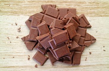 Top View of chocolate chunks pile on wooden backdrop