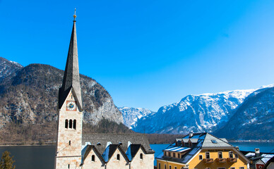Panoramic view of the famous Hallstatt mountain village and the parish church of Maria Himmelfahrt...