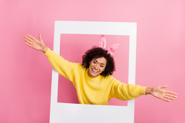Photo of impressed sweet woman dressed kitted pullover easter headband open arms photo frame...