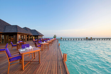 Outdoor restaurant at the beach Romantic Sunset view in Maldives Island