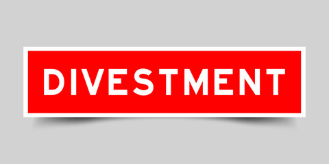 Sticker label with word divestment in red color on gray background