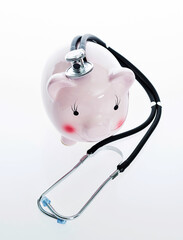 Piggy bank and stethoscope isolated on white background