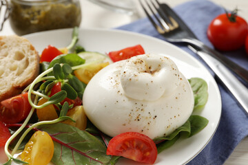 Delicious burrata salad with tomatoes served on table, closeup