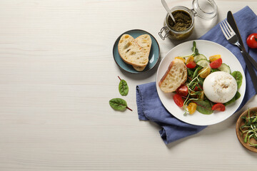 Delicious burrata salad served on white wooden table, flat lay. Space for text