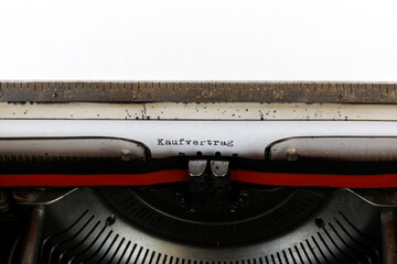 The German word Kaufvertrag written on an old mechanical typewriter German Text: Purchase contract