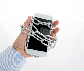 Iron chain ties together hand and smart phone