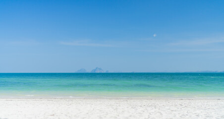Fototapeta na wymiar Clear beach with moutain background and beautiful blue sky