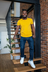 Man descending stairs in apartment