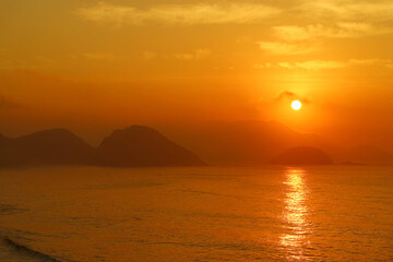 Naklejka na ściany i meble Stunning sunrise over the Atlantic ocean view from Copacabana beach, Rio de Janeiro, Brazil