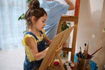 Art class. Adorable children paint on canvas. The concept of hobbies, art, creativity and children's entertainment