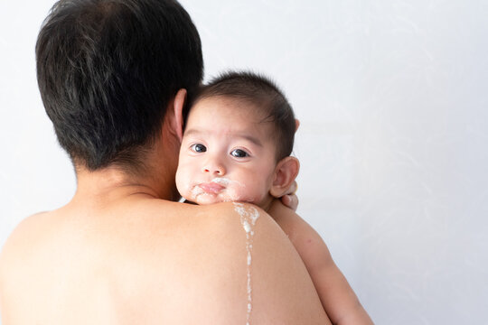 Close up of asian father is carring his baby to belching after breast feeding time, conceptnof parent care to the child and over feeding in baby.