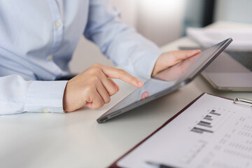 Business concept, Businesswoman researching and checking of marketing data on tablet in office