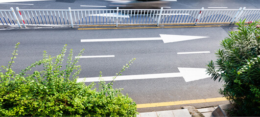 Straight forward arrow direction sign on asphalt ground