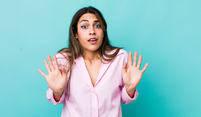 pretty hispanic woman looking nervous, anxious and concerned, saying not my fault or I didn’t do...