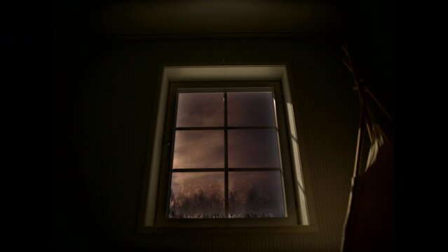 Time lapse of starry night sky through residential window