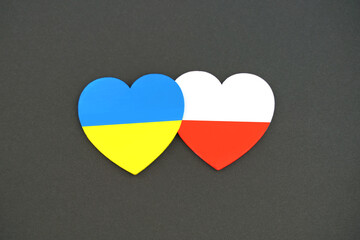 Flag of Ukraine and Poland. Two hearts isolated on black background. Concept of solidarity and help