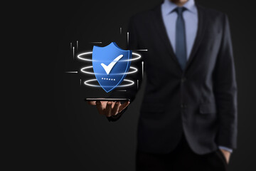 Businessman hold low poly polygon shield with a tick icon.Secure Access System Concept.Business...