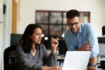 Colleagues in office. Businesswoman and businessman discussing work in office.