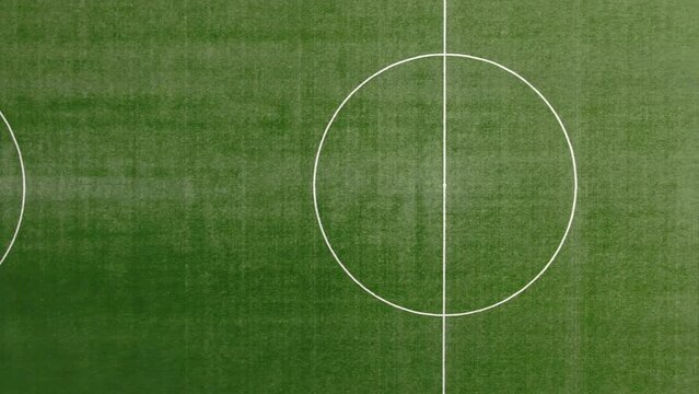 Top view of football or soccer field with green grass and borders lines, top view