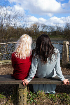 Lesbian couple sitting by the river