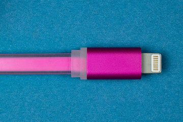 Usb lightning pink data cable on blue