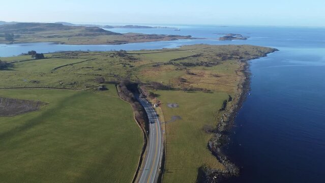Byfjord tunnel in Stavanger going down 223 meters below sea level - Cars coming up from tunnel going below sea level - Sunny day aerial overview