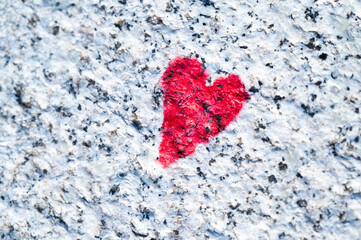 Red heart drawn on stone. Love, feelings, solidarity and duration of feelings.
