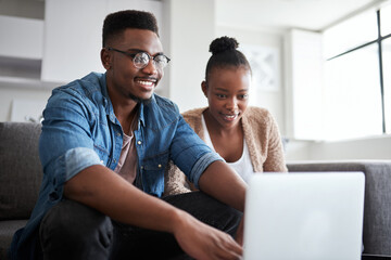 Look at this brand new budget plan I created. Shot of a young couple using a laptop together at home.