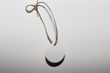 Fototapeta na wymiar White label with sisal cord. Adornment to tie on gift.