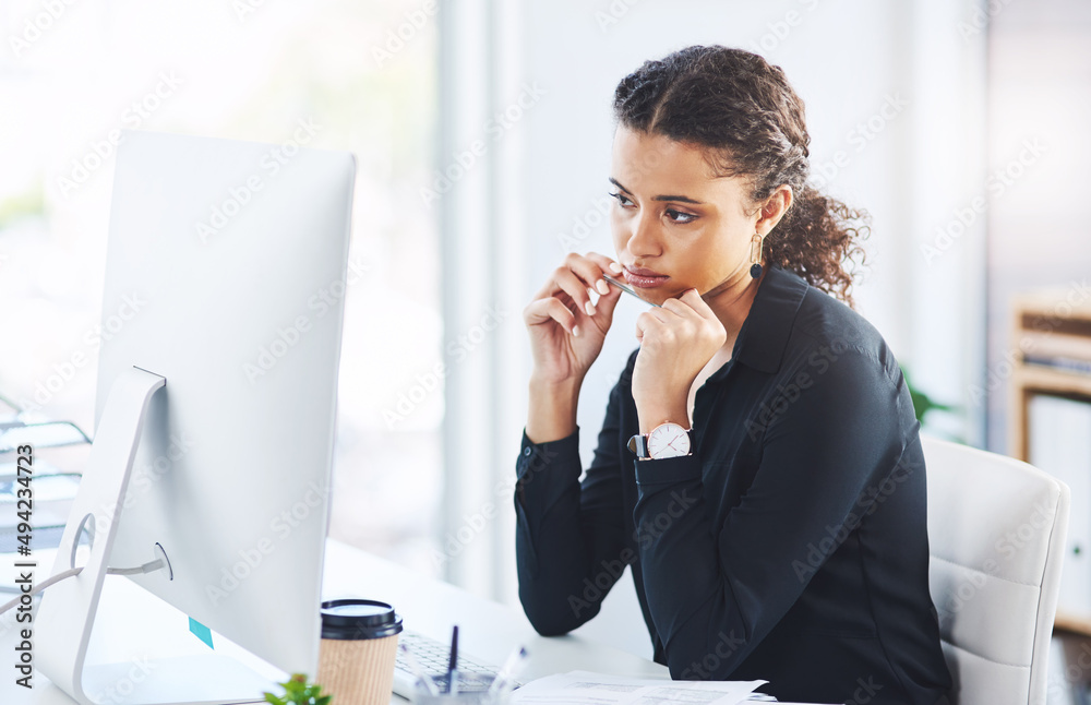 Poster maybe desk jobs are not meant for me. shot of a young businesswoman looking bored while working on a