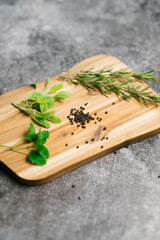 Wooden cutting board vertical mockup with spices on a grey background