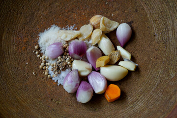 some kitchen spices on a mortar from clay ready to be mashed