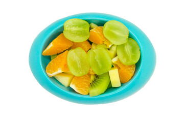 seedless grapes orange kiwi apples cut in pieces in blue oval shaped bowl or plate on isolated white background with clipping path