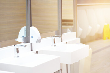 Sink in toilet with blur urinal and awareness board