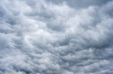 A dark cloudy sky announcing a thunderstorm offering different shades of gray.