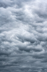 A dark cloudy sky announcing a thunderstorm offering different shades of gray.